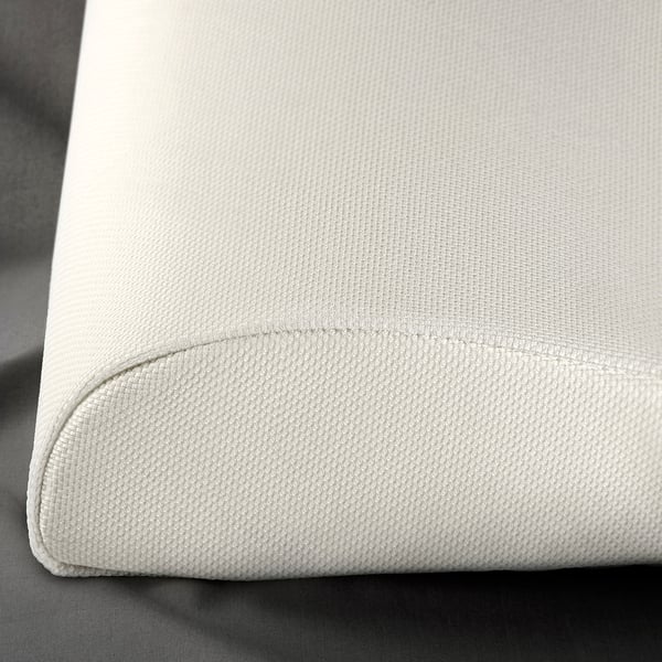 Close-up of a soft, textured white cushion, likely made with recycled polyester and memory foam.