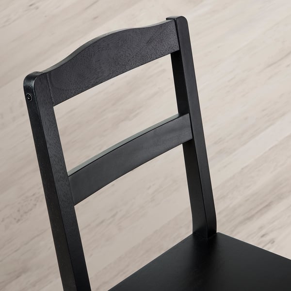 Black wooden chair backrest with a sleek, minimalist design. Strong and stylish, showcasing high-quality craftsmanship.