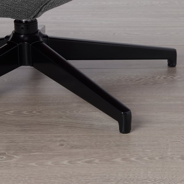 Black office chair leg on wooden floor. Sturdy, modern design.