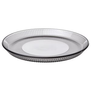 Round grey glass plate with vertical line design.