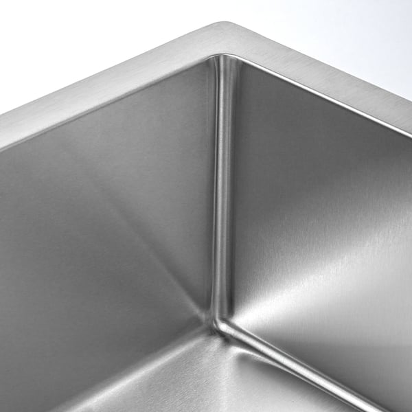 Stainless steel sink with smooth, rounded edges; reflects light, indicating high quality.