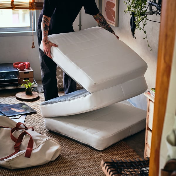 Foldable mattress transforms from pouffe to bed.