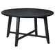 Black round KRAGSTA table, solid mango wood, four angled legs.