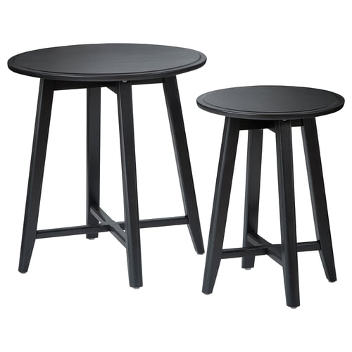 Two black round nesting tables with sleek legs and smooth tops, made from solid mango wood, stylish and functional.