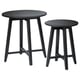 Two black round nesting tables with sleek legs and smooth tops, made from solid mango wood, stylish and functional.