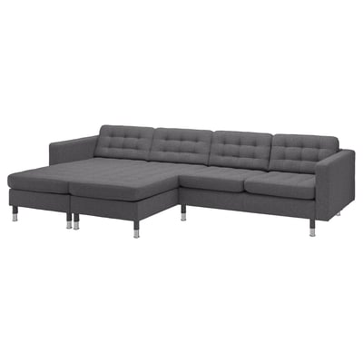 Modern black l-shaped sofa with chrome legs, tufted cushions, and sleek design.