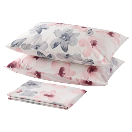 Neatly arranged pink and grey floral pillows and sheet for cosy decor.