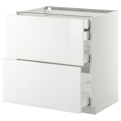 A METOD white kitchen cabinet with glossy white ringhult fronts, featuring multiple drawers.