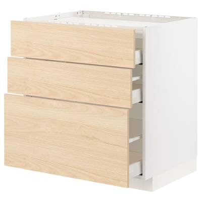 This image shows a white kitchen cabinet unit with three wooden drawers, a modern and minimalist design.