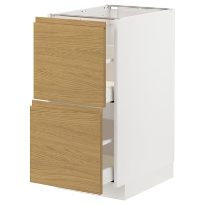 White kitchen cabinet with oak wooden drawers, modern minimalist design.