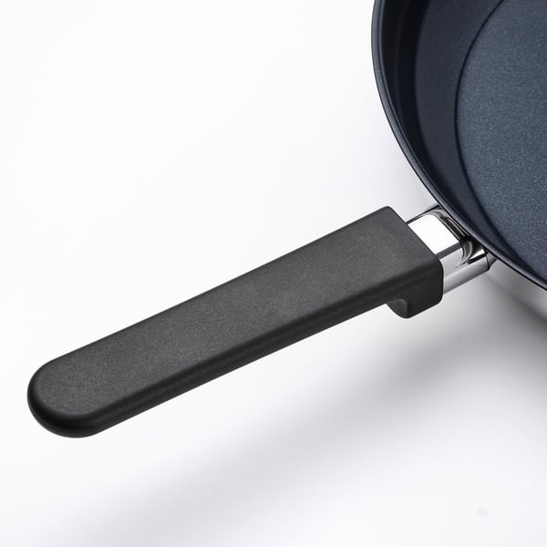 Black frying pan with ergonomic phenolic handle, featuring a sleek and modern design, ideal for efficient cooking.