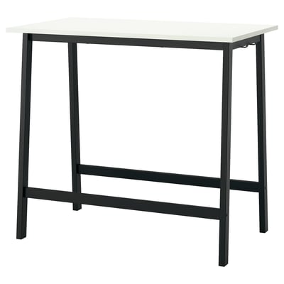 A MITTZON high conference table with a white top and black metal legs. Its designed for sitting or standing, with footrests on both sides.
