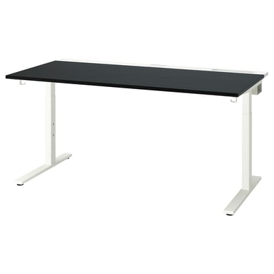 The MITTZON height-adjustable desk a black tabletop and white metal legs, offering a sleek and modern design.