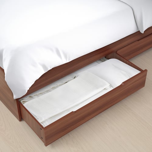 Bed with pull-out storage. Wooden frame, white linens. Easy access for storage.