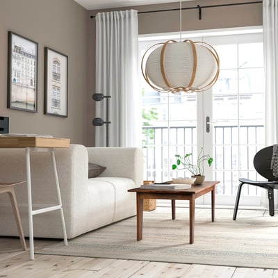 Minimalist mango wood coffee table with decor in bright living room.