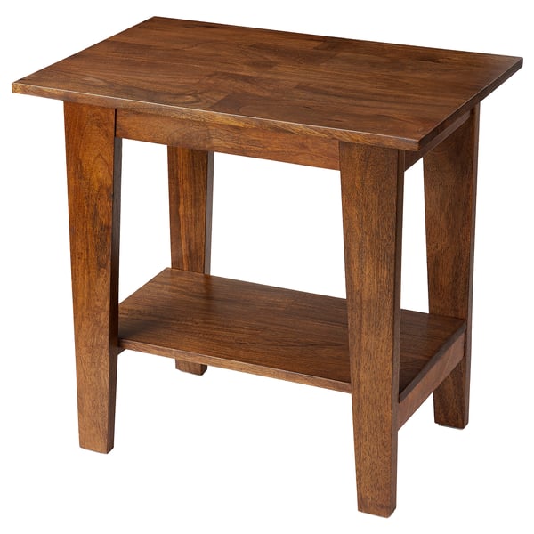 A wooden table named NORRVÅGA, rectangular with one shelf, made from mango wood with a rich brown finish.