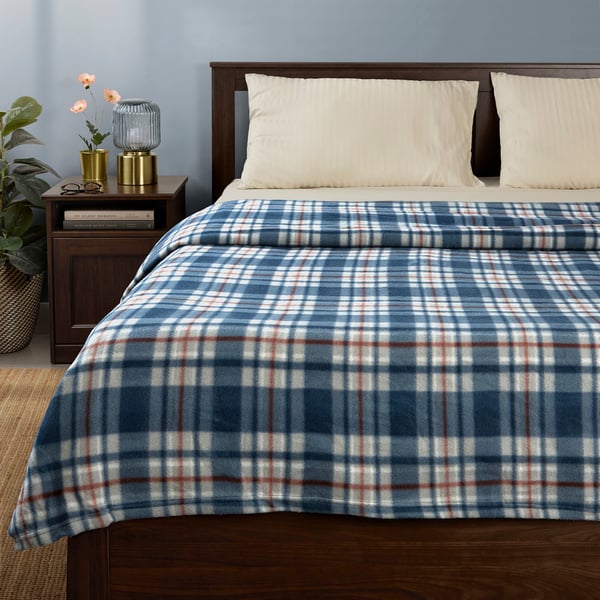 ODENSLÄTA blue/red plaid blanket on bed, with white sheets, recycled polyester.