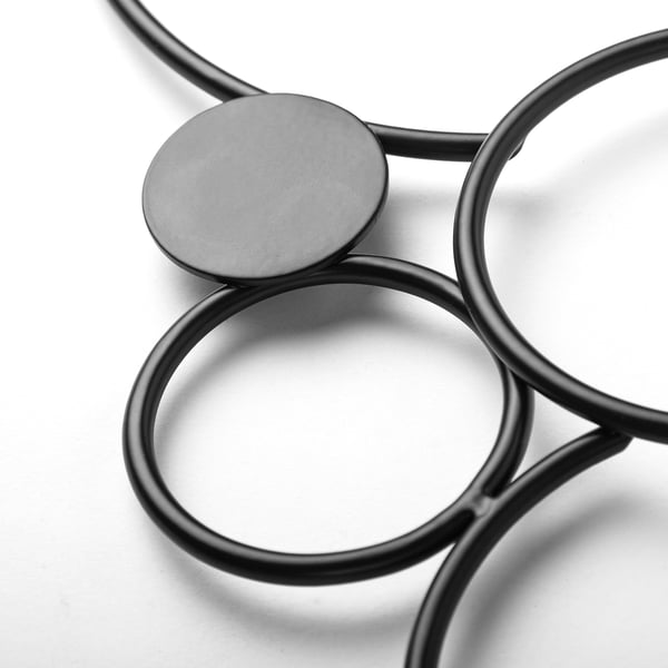 Interlocking circular metal wall decor. Modern design, smooth finish.