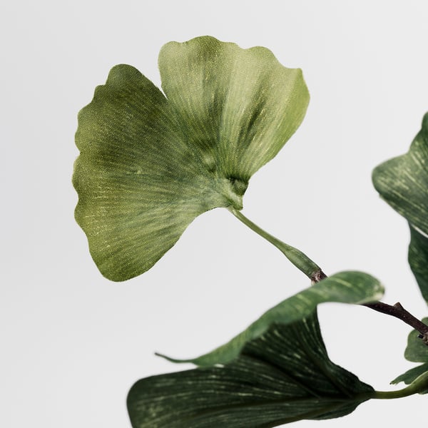 Artificial ginkgo leaves, lifelike and detailed, attached to a flexible stem.