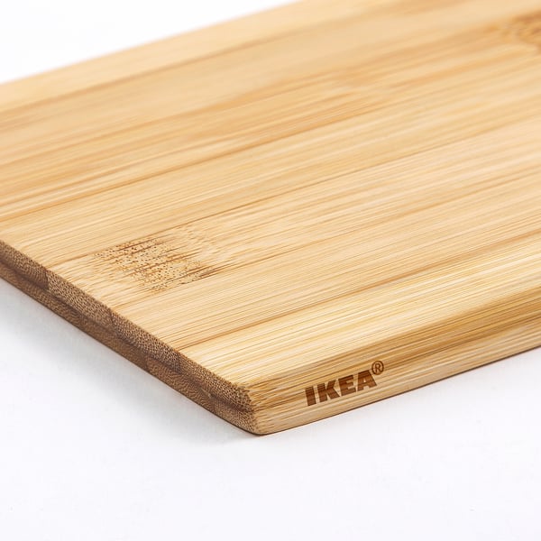 Light-colored IKEA bamboo cutting board on a white surface.