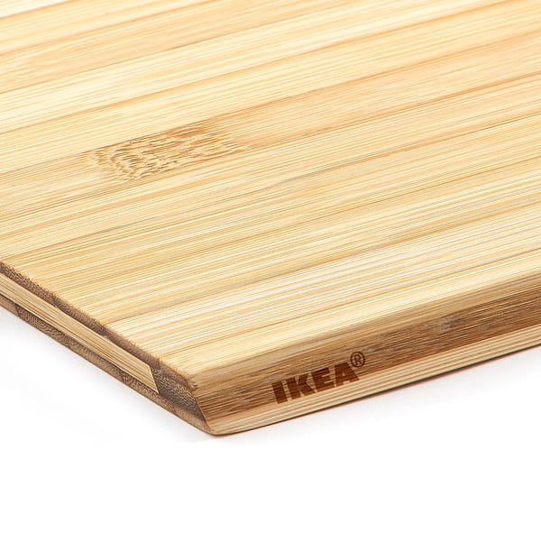 Bamboo cutting board, smooth and well-crafted, displayed at an angle showcasing its natural grain and brand marking.
