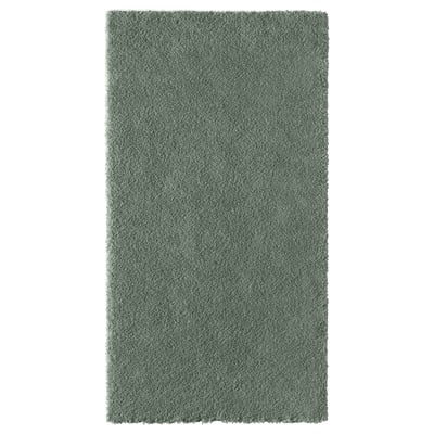 A rectangular, light green STOENSE rug with a low, soft pile, featuring a subtle sheen and a harmonious design.