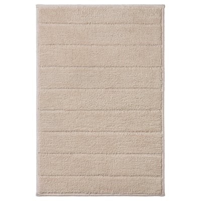 Beige TIDNINGSBUD bath mat with horizontal stripes, textured recycled polyester for quick drying.