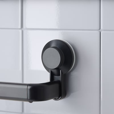 A black TISKEN towel rack, sleek and extendable, featuring robust suction cups for secure wall mounting.