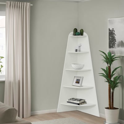 White 5-tier shelf in corner holding plants, bowl, books, picture.