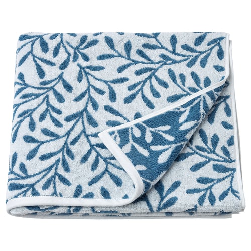 Folded blue-and-white leaf-patterned bath towel made of cotton.