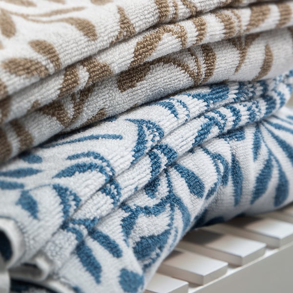Stacked VITBACKEN towels, blue and white leaf patterns, soft cotton terry, rectangular.