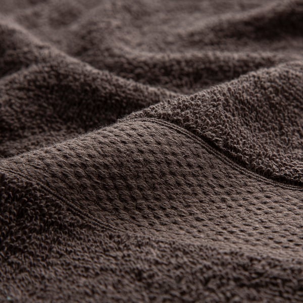 Close-up of thick, high-quality cotton towel, soft and absorbent, folded neatly.