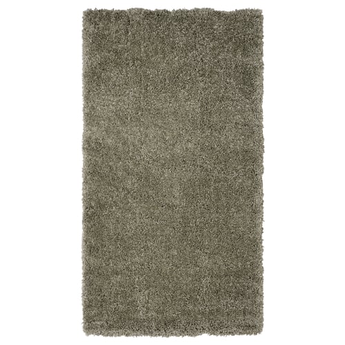 The VOLLERSLEV rug is a plush, textured grey shaggy rug, perfect for bedrooms, offering comfort and sound dampening.