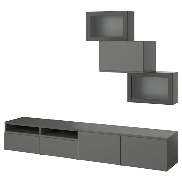 Un mobile tv BESTÅ grigio scuro con tre mobili a muro e un lungo mobile tv. Design moderno ed elegante con ampio spazio di archiviazione.