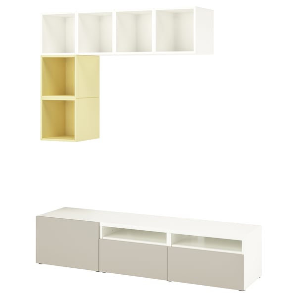 Un mobile portatv BESTÅ bianco. Include ripiani e armadietti per lo stoccaggio, con un design minimalista.