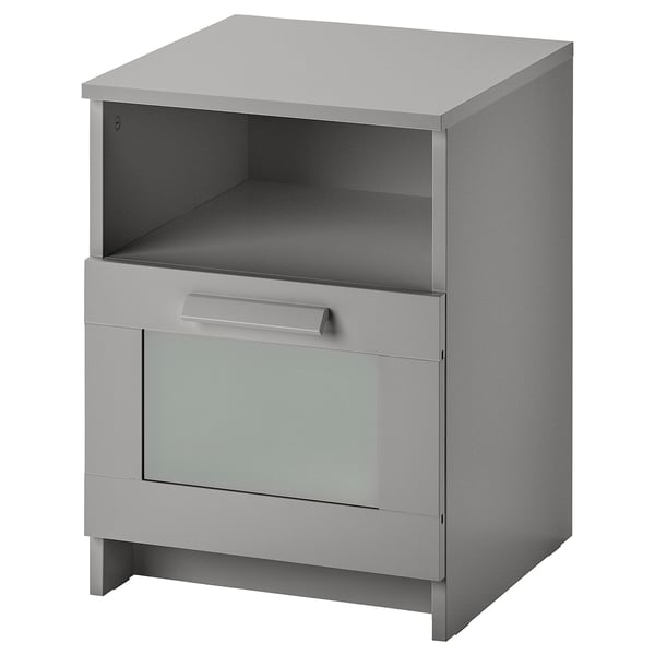 Tavolino BRIMNES grigio con ripiano superiore aperto, cassetto singolo e pannello frontale in vetro.