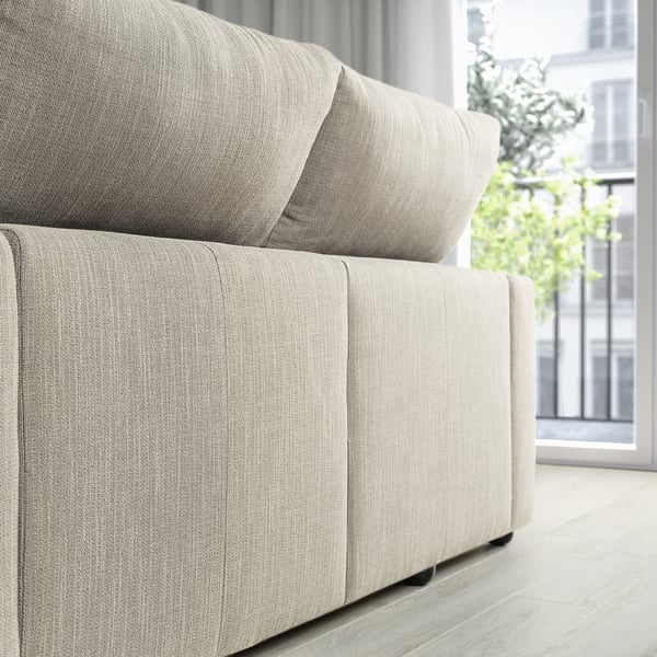 Moderno divano ESKILSTUNA grigio chiaro con poggiatesta regolabili e chaise longue, che offre un'esperienza di seduta spaziosa e confortevole.