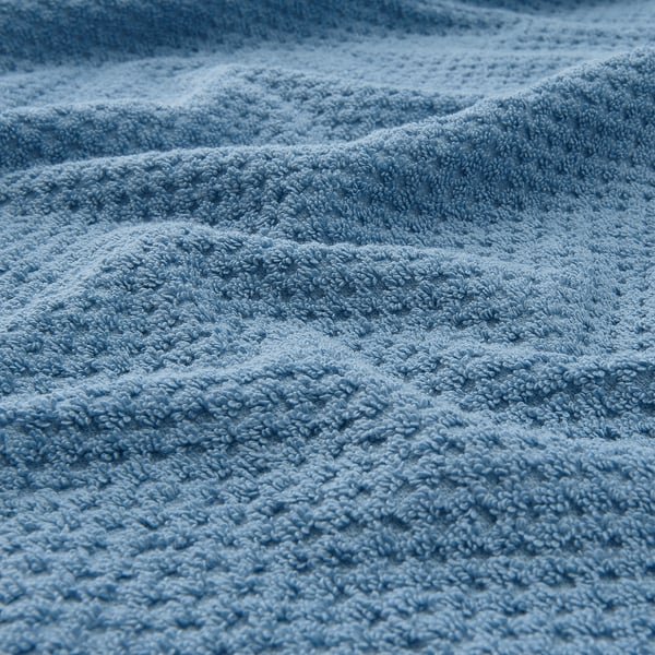 Primo piano di un asciugamano morbido e soffice che mostra il suo materiale di cotone strutturato.
