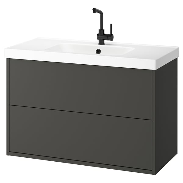 Mobile bagno moderno grigio sospeso con piano di lavoro e lavandino bianchi, rubinetto nero.
