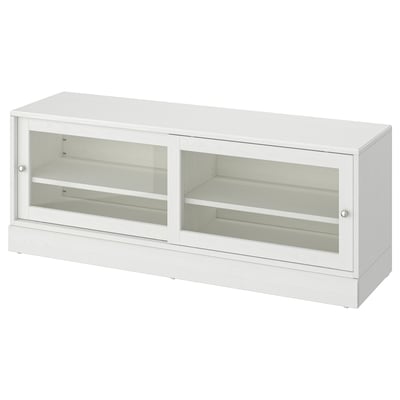 Un mobile tv HAVSTA bianco con ante scorrevoli in vetro, realizzato in pino massiccio, offre un design rustico e moderno per l'archiviazione domestica.