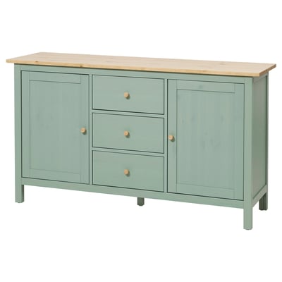 Una madia HEMNES verde chiaro con piano in legno, caratterizzata da tre cassetti e due ante con pomelli in legno.