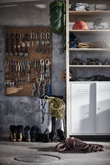 Garage con deposito IVAR - ripiani marroni, armadio bianco, attrezzatura da arrampicata.