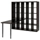 Una combinazione ikea: scrivania nera con gambe regolabili fissata a uno scaffale alto KALLAX marrone scuro.