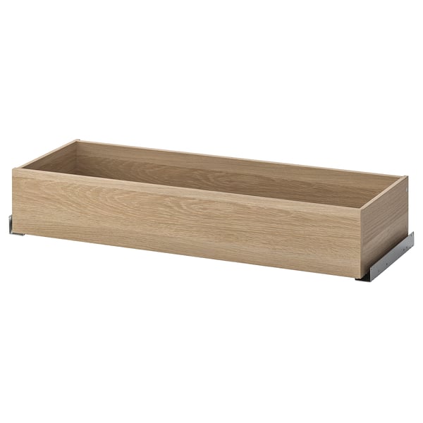 Un cassetto in legno vuoto della serie KOMPLEMENT, ideale per organizzare vestiti e accessori, con un'elegante finitura naturale.