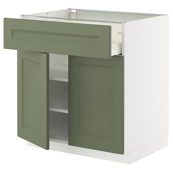 Un mobile da cucina METOD verde e bianco con cassetto e anta aperta che rivela gli scaffali all'interno.