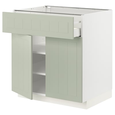 Un mobile da cucina METOD in verde con cassetto liscio e due ripiani, caratterizzato da un design artigianale.