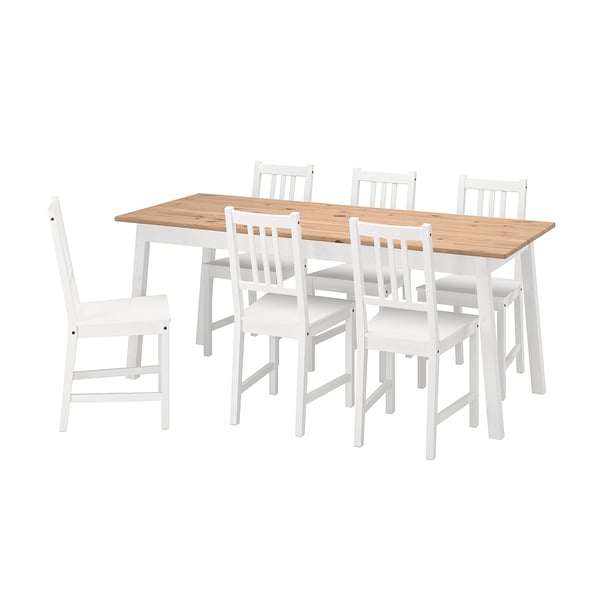 Un set da pranzo in pino e legno bianco chiamato PINNTORP, che include un tavolo rettangolare e sei sedie abbinate con schienale alto.