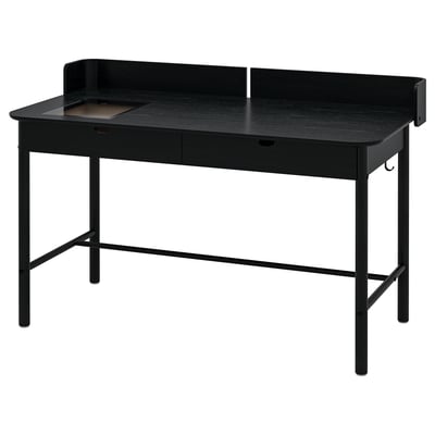 Una scrivania RIDSPÖ nera con scudo curvo, due cassetti e un cassetto con piano in vetro. Design moderno e funzionale in nero.
