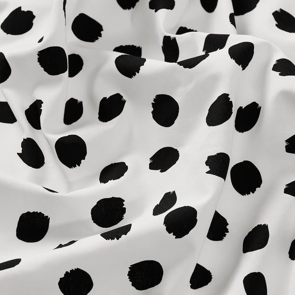 Tessuto bianco e nero con grandi motivi a tampone; trama di cotone di alta qualità, adatta per progetti di cucito.