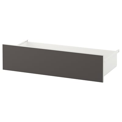 Una cassettiera SKATVAL di colore bianco con pannello frontale grigio. Ha una forma rettangolare con un design elegante e minimalista.